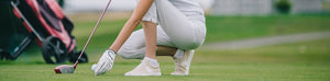 Golfer teeing up golf ball