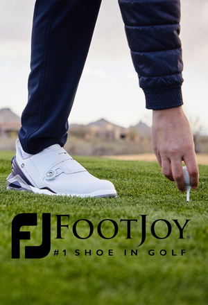 Golfer wearing FootJoy shoes teeing up golf ballteeing
